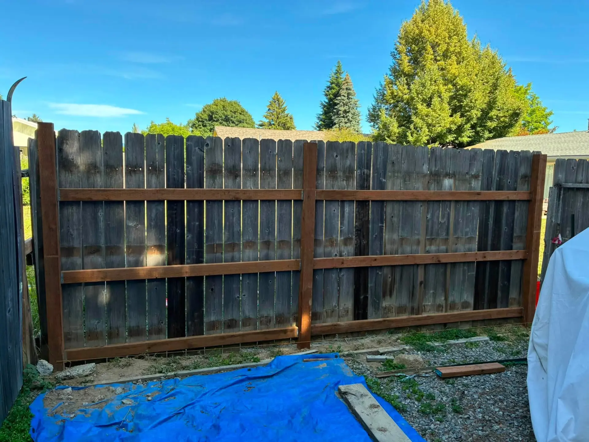 Fence rebuilt with new posts and rails in a Sandpoint backyard